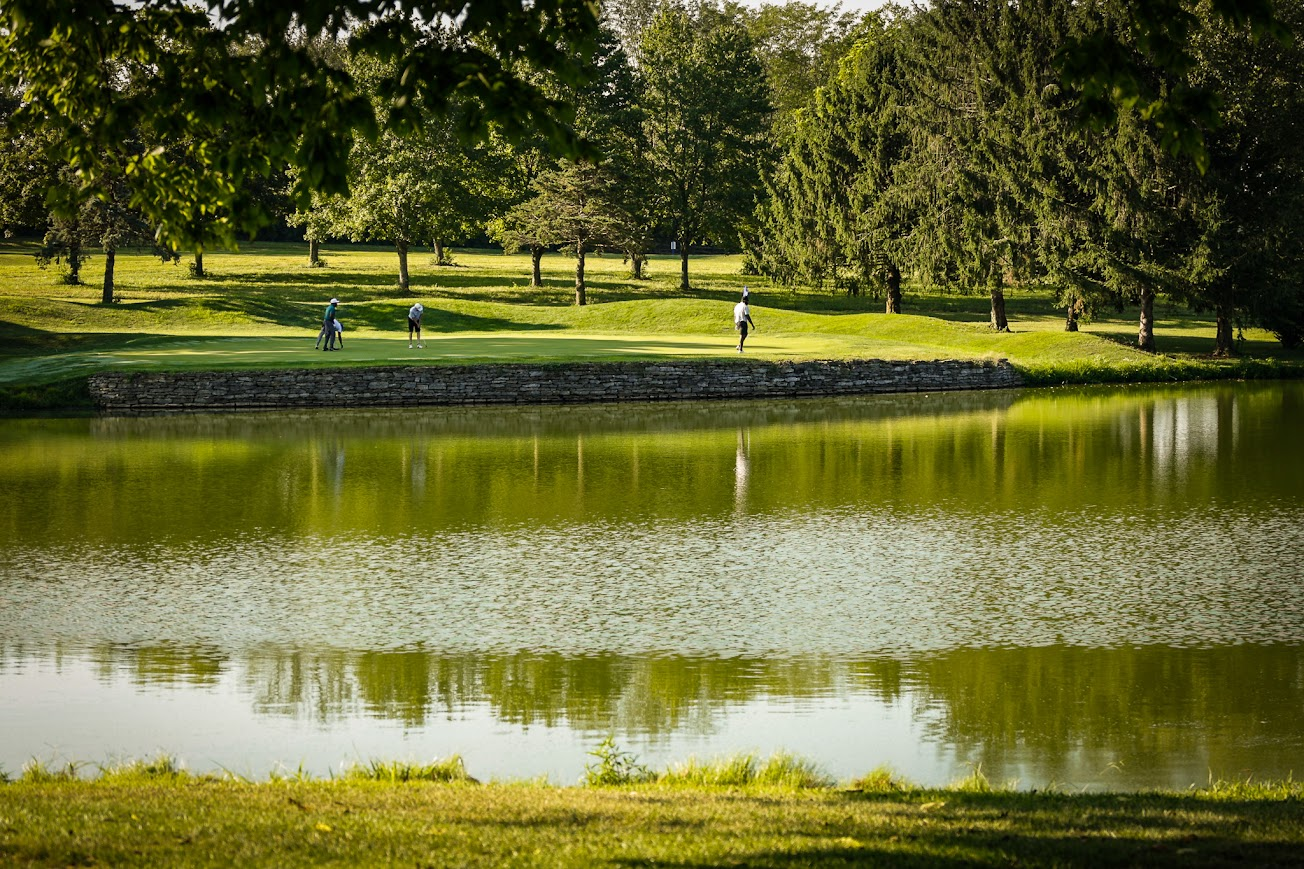 Golfers on the course beside the water