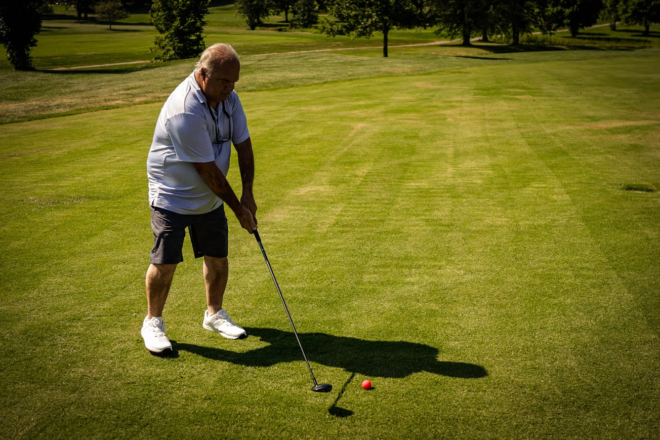 Golfer preparing to drive from the tee box