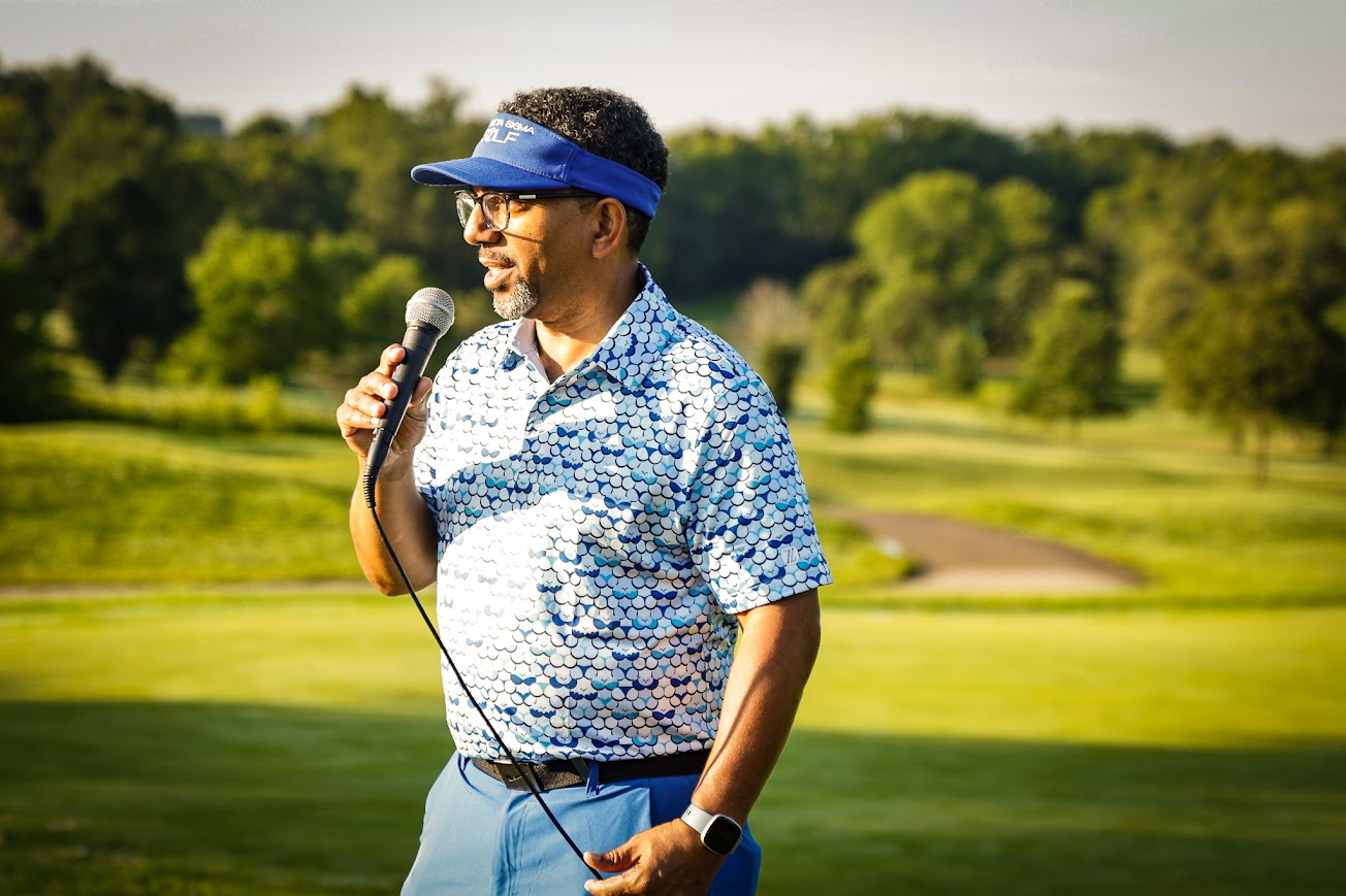 Speaker addressing golfers on the course